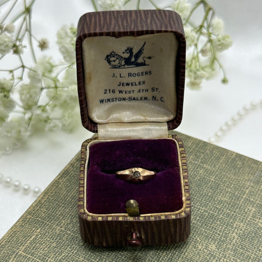 Vintage bronze tone baby ring with small stone and original ring box.