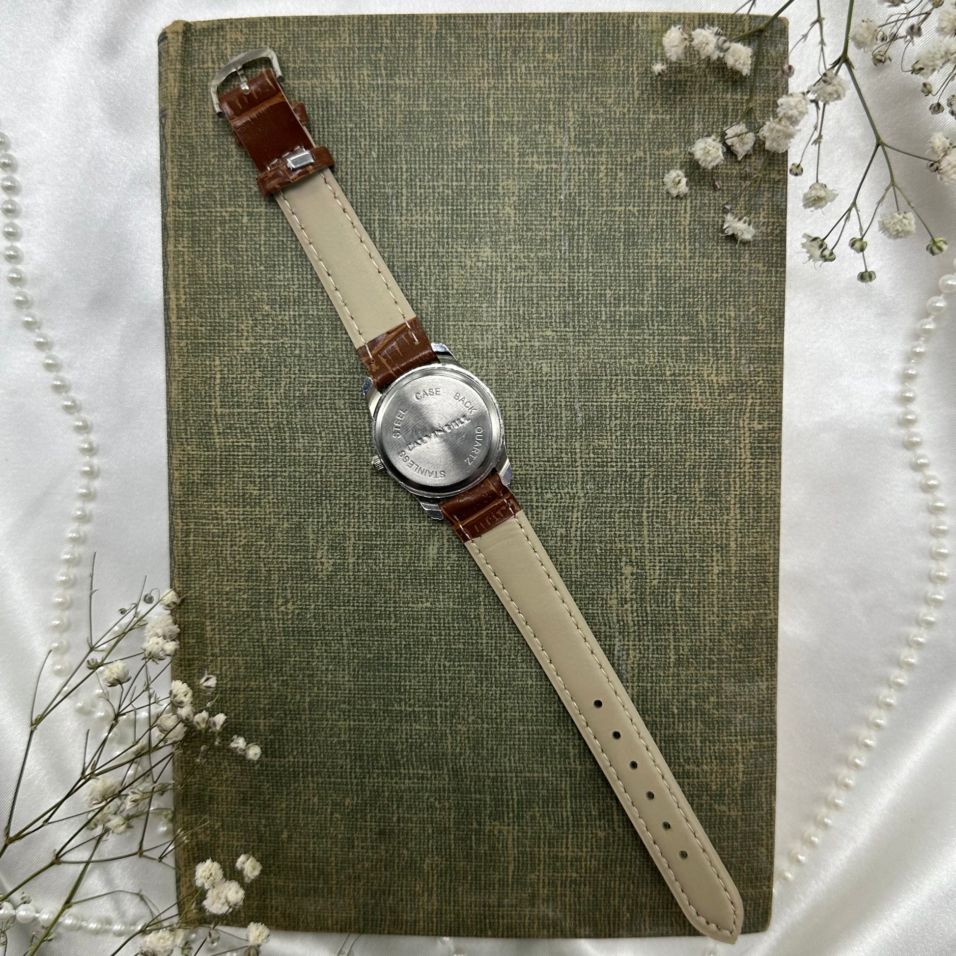 Vintage brown and silver tone watch with brown strap