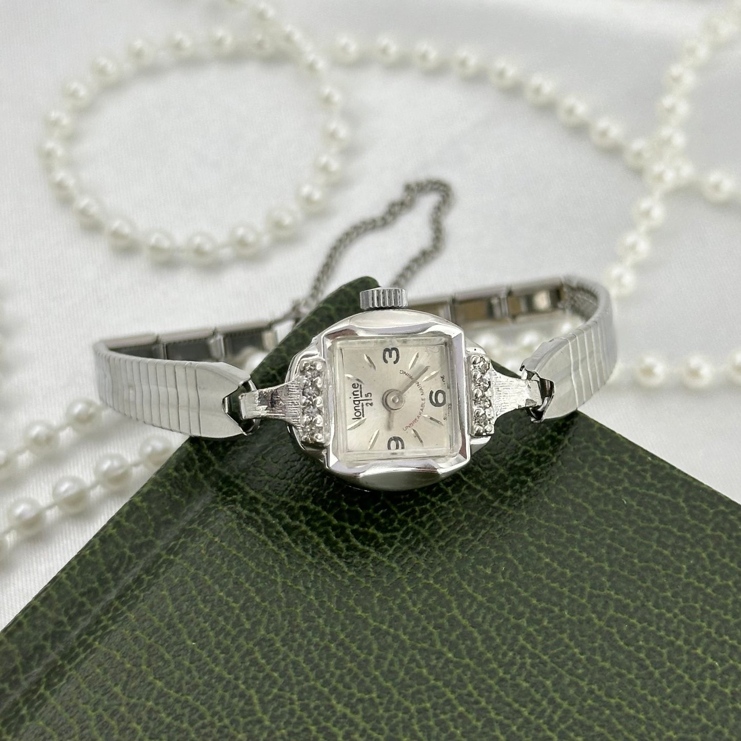 Vintage dainty silver tone Endura 25 jewels manual winding watch with silver detailed clasp band, diamanté bezel and safety clasp from the 1970's.