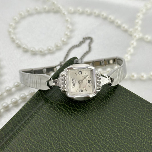 Vintage dainty silver tone Endura 25 jewels manual winding watch with silver detailed clasp band, diamanté bezel and safety clasp from the 1970's.