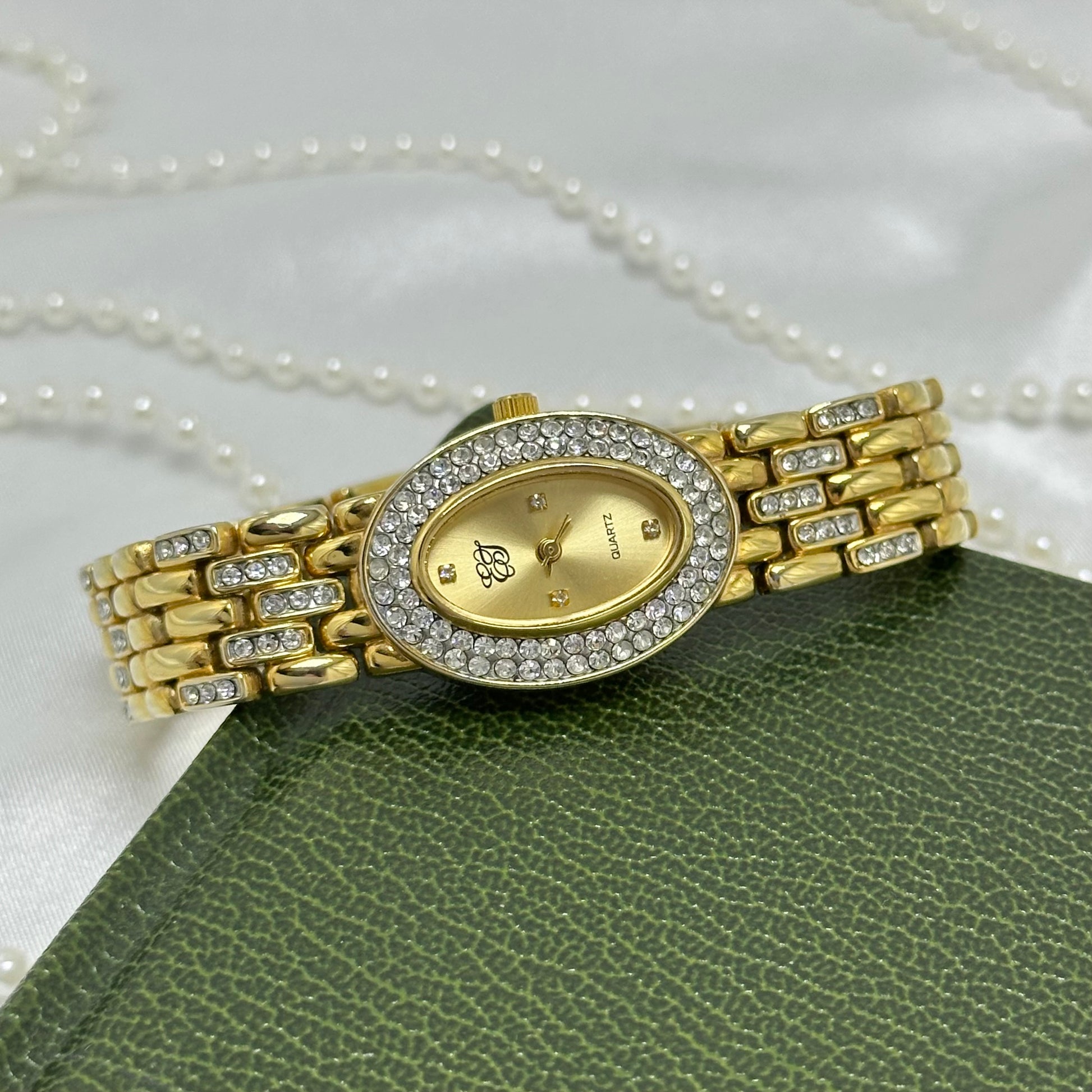 Vintage elegant crystal gold tone Elizabeth Taylor watch with diamanté band and oval dial.