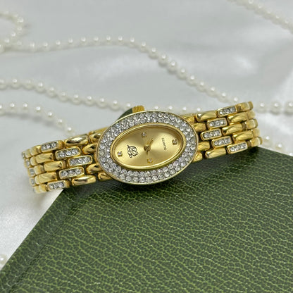 Vintage elegant crystal gold tone Elizabeth Taylor watch with diamanté band and oval dial.