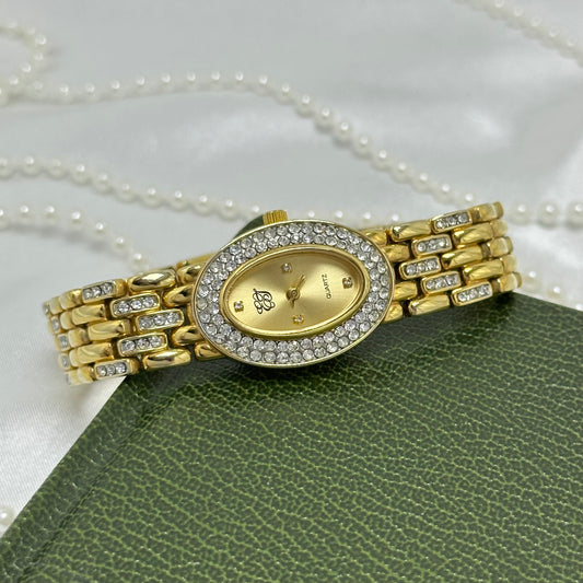Vintage elegant crystal gold tone Elizabeth Taylor watch with diamanté band and oval dial.