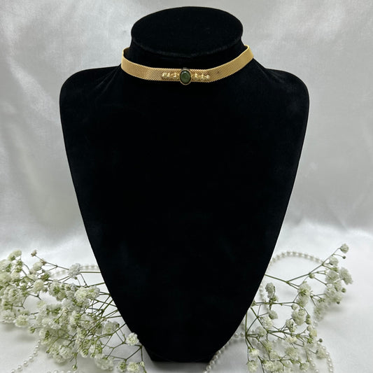 Vintage gold choker necklace with green stone and hook clasp. There is a small dot of discoloration