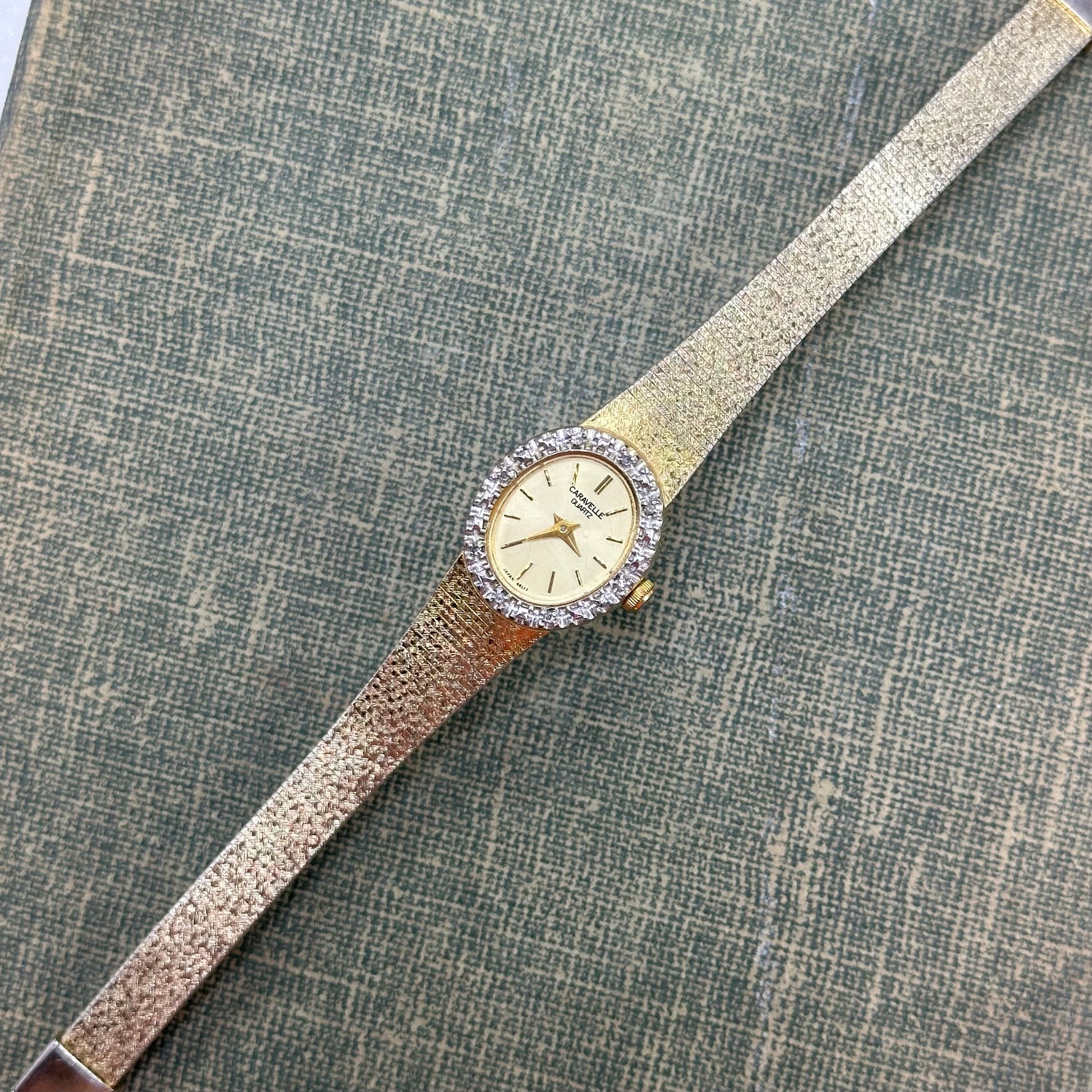 Vintage gold tone diamanté Caravelle by Bulova watch with metal clasp band and quartz movement.
