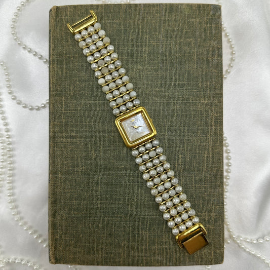 Vintage gold tone Anne Klein watch with pearl bead band and mother of pearl dial.