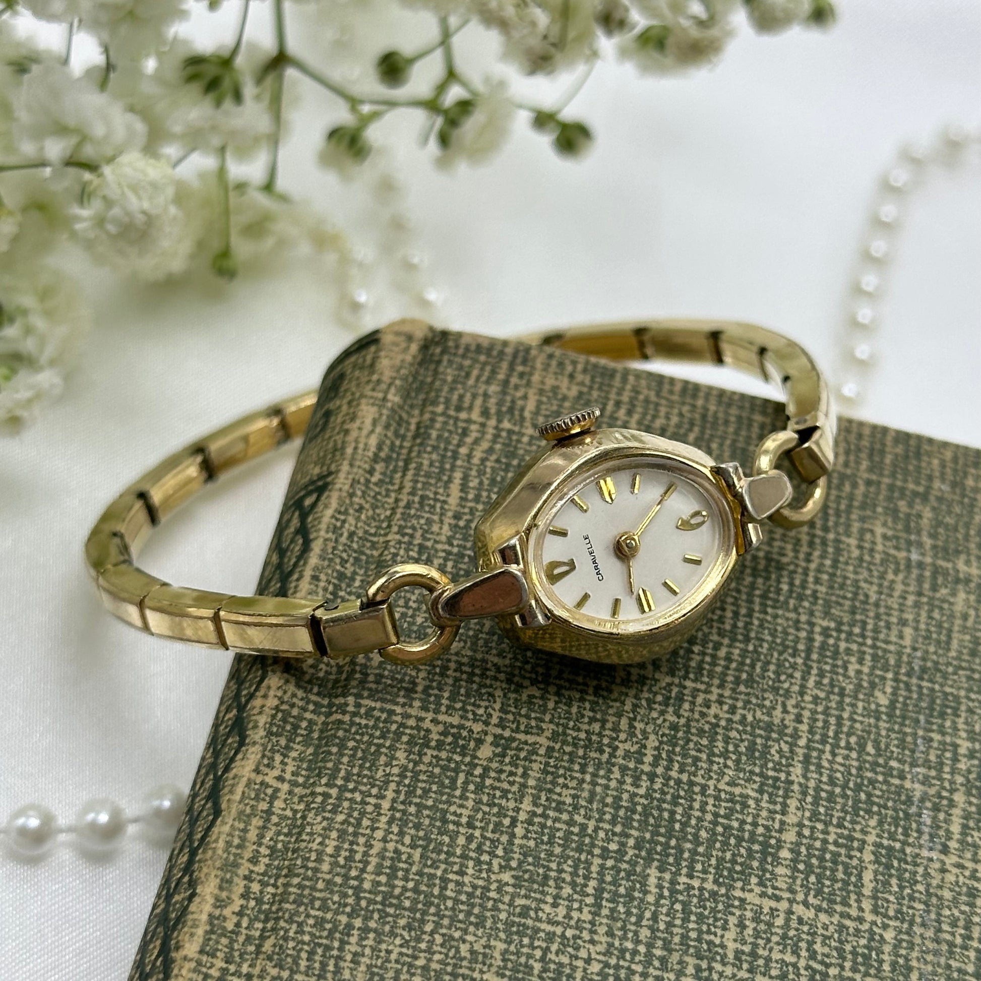 Vintage gold tone Caravelle manual winding watch with stretchable band from the 1960's.