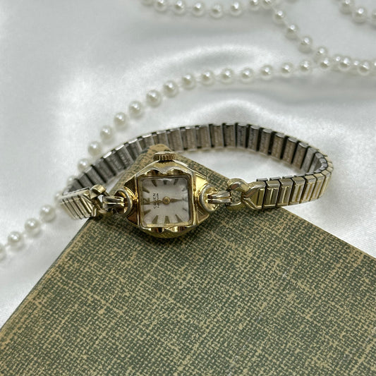 Vintage gold tone Gruen manual winding watch with stretchable band from the 1950's.