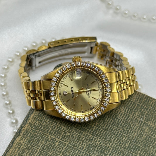 Vintage gold tone Gruen watch with diamante gemstones and date display. Watch is water resistant with quartz movement.