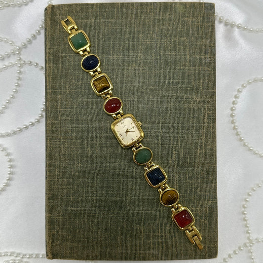 Vintage gold tone Kenneth Jay Lane watch with multicolor scarab band and quartz movement.