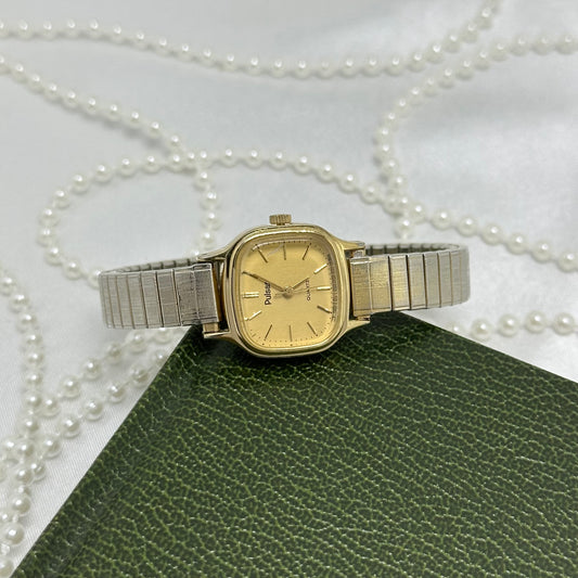 Vintage gold tone Pulsar by Seiko watch with square dial and stretchable band.