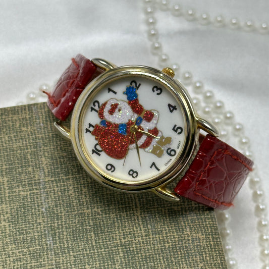 Vintage gold tone Santa watch with glitter dial and red leather band.