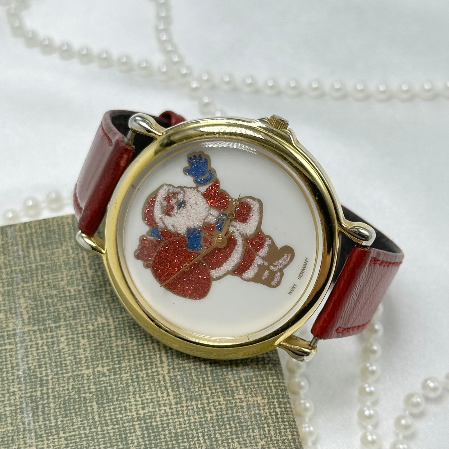 Vintage gold tone Santa watch with glitter dial and red leather band.2