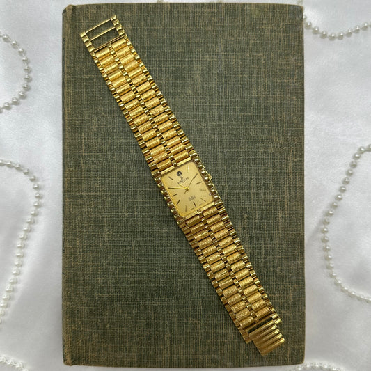 Vintage gold tone chunky tank Berenger watch with rectangle dial and clasp band.