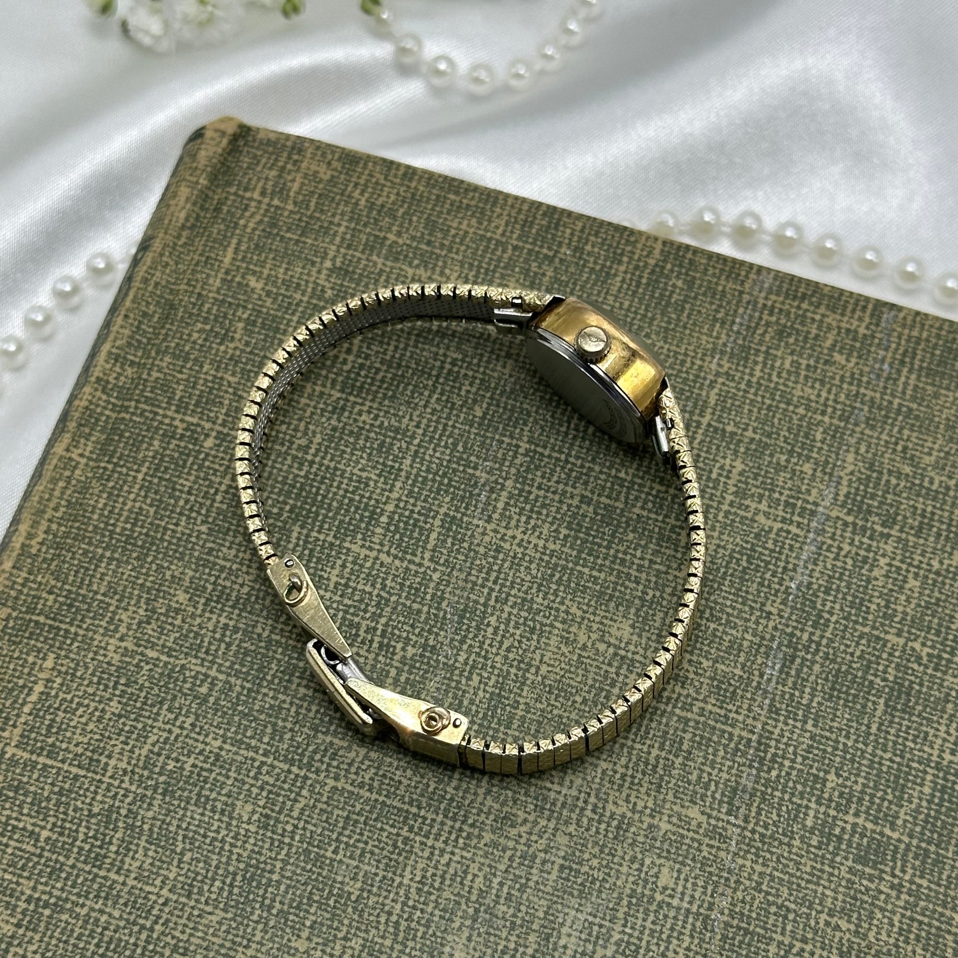 Vintage gold tone dainty watch with black dial quartz movement