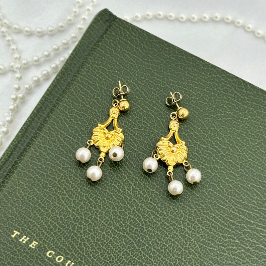 Vintage gold tone dangle earrings with faux pearls.