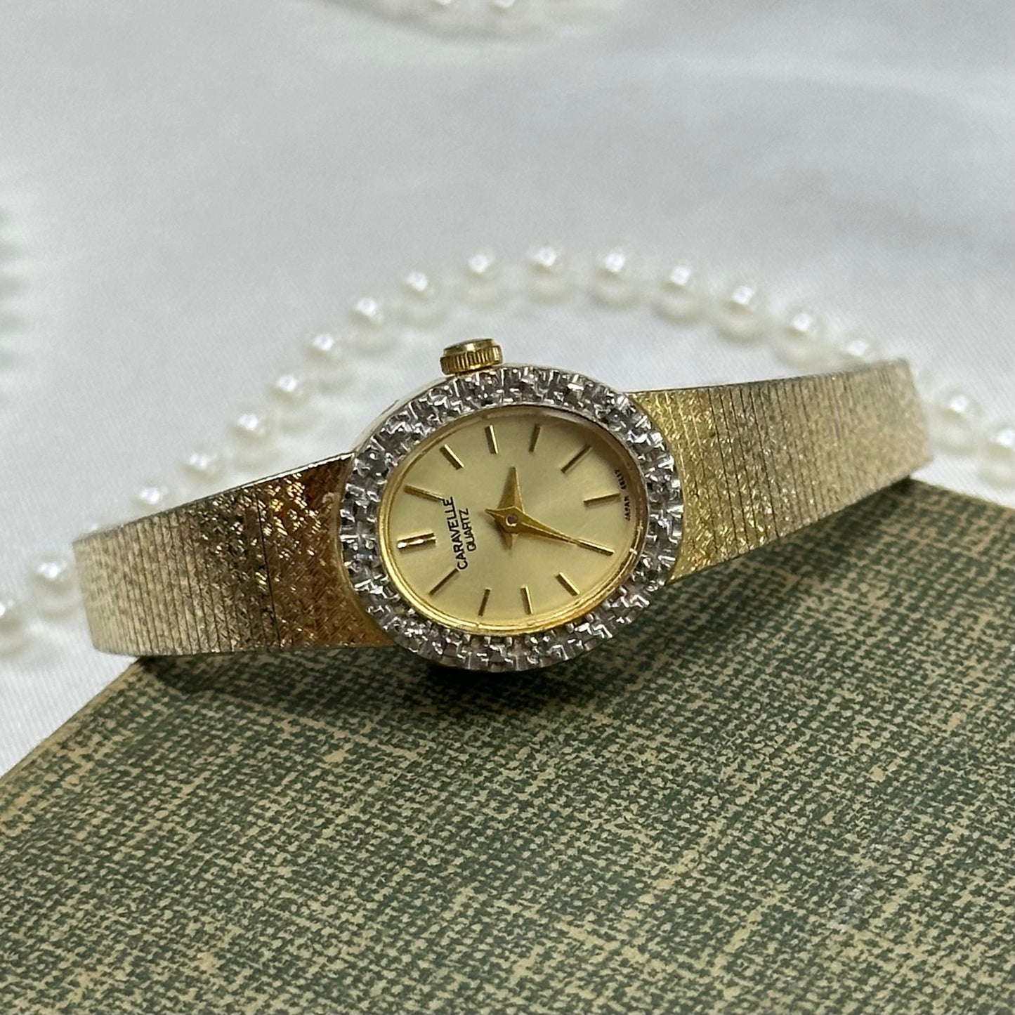 Vintage gold tone diamanté Caravelle by Bulova watch with metal clasp band and quartz movement.