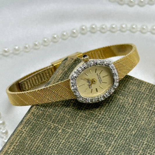 Vintage gold tone diamanté Dufonte Lucien Piccard watch with quartz movement and blue jewel crown.