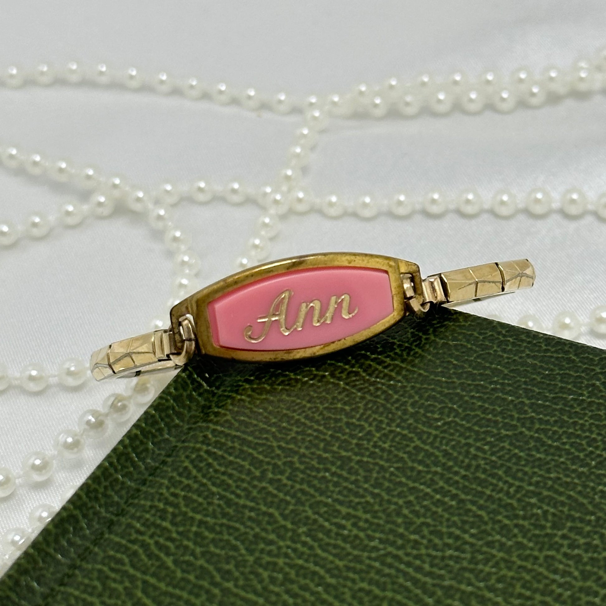 Vintage gold tone engraved bracelet with pink "Ann" name plate and stretchable band.