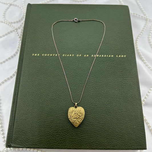 Vintage gold tone heart locket necklace with filigree and “Love Forever” engraved.&