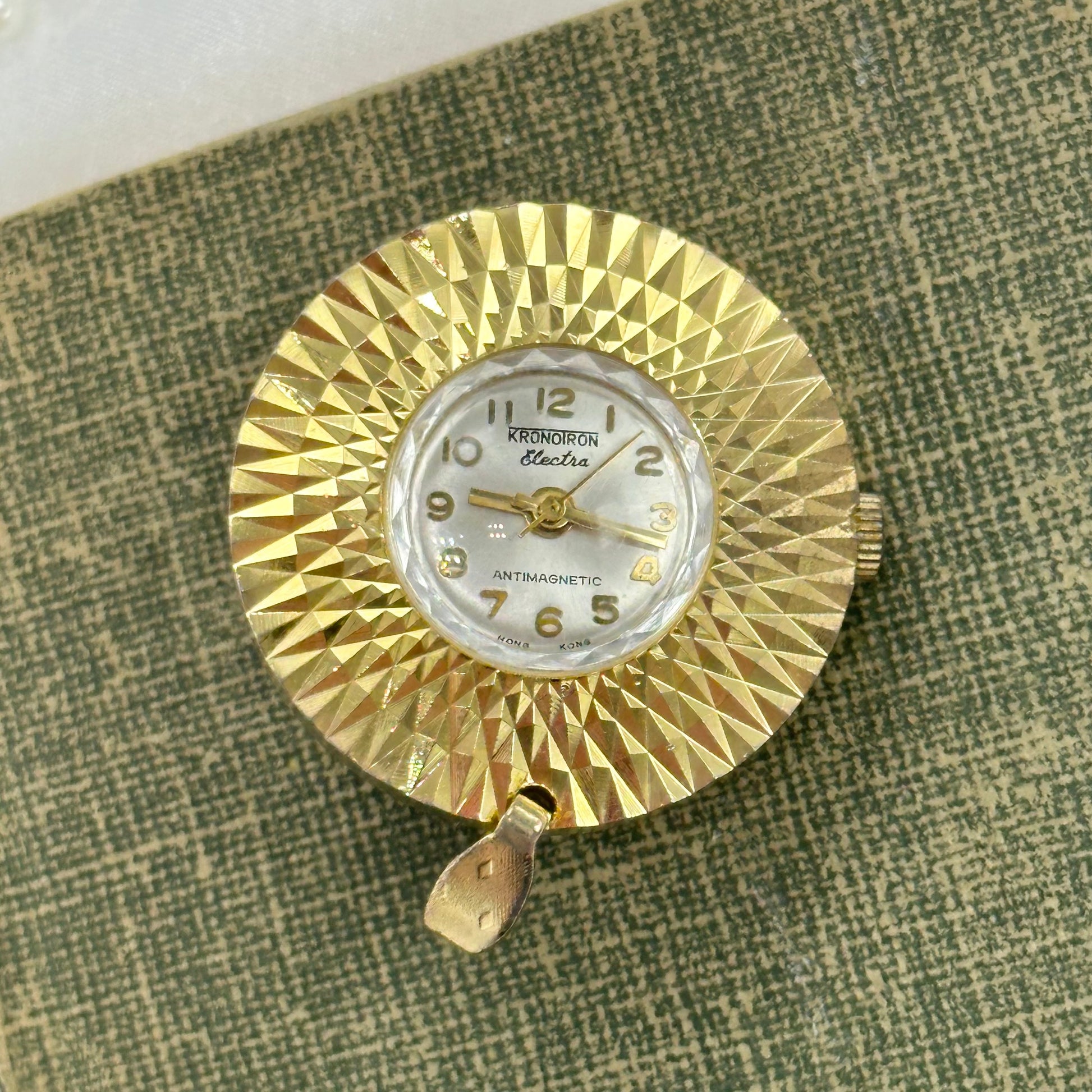 Vintage gold tone manual winding Kronoiron Electra antimagnetic pendant watch with round faceted bezel.&nbsp;