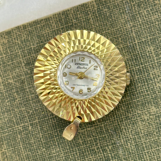 Vintage gold tone manual winding Kronoiron Electra antimagnetic pendant watch with round faceted bezel.&nbsp;