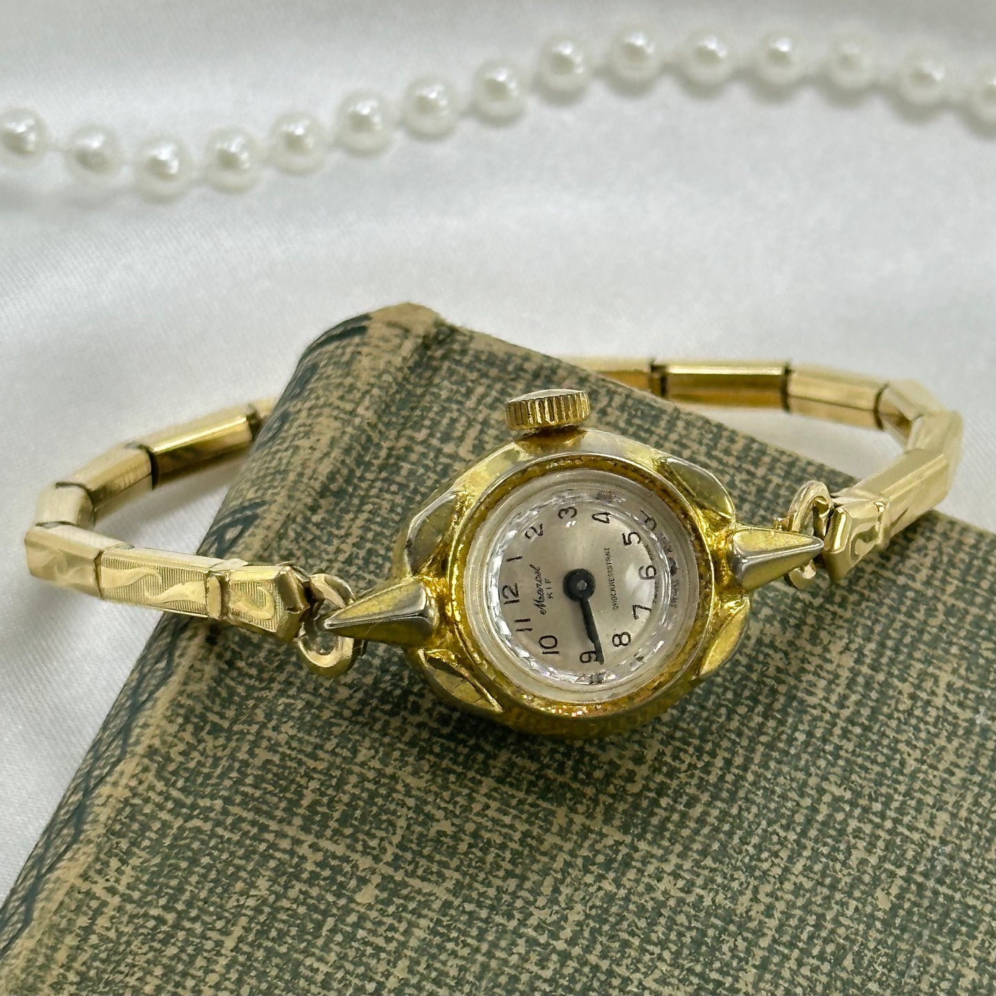 Vintage gold tone manual winding cocktail Marcel Swiss made watch with stretchable band.