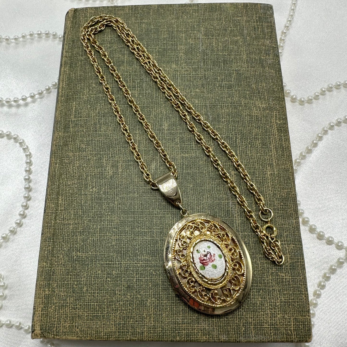 Vintage gold tone necklace with floral and filigree locket.