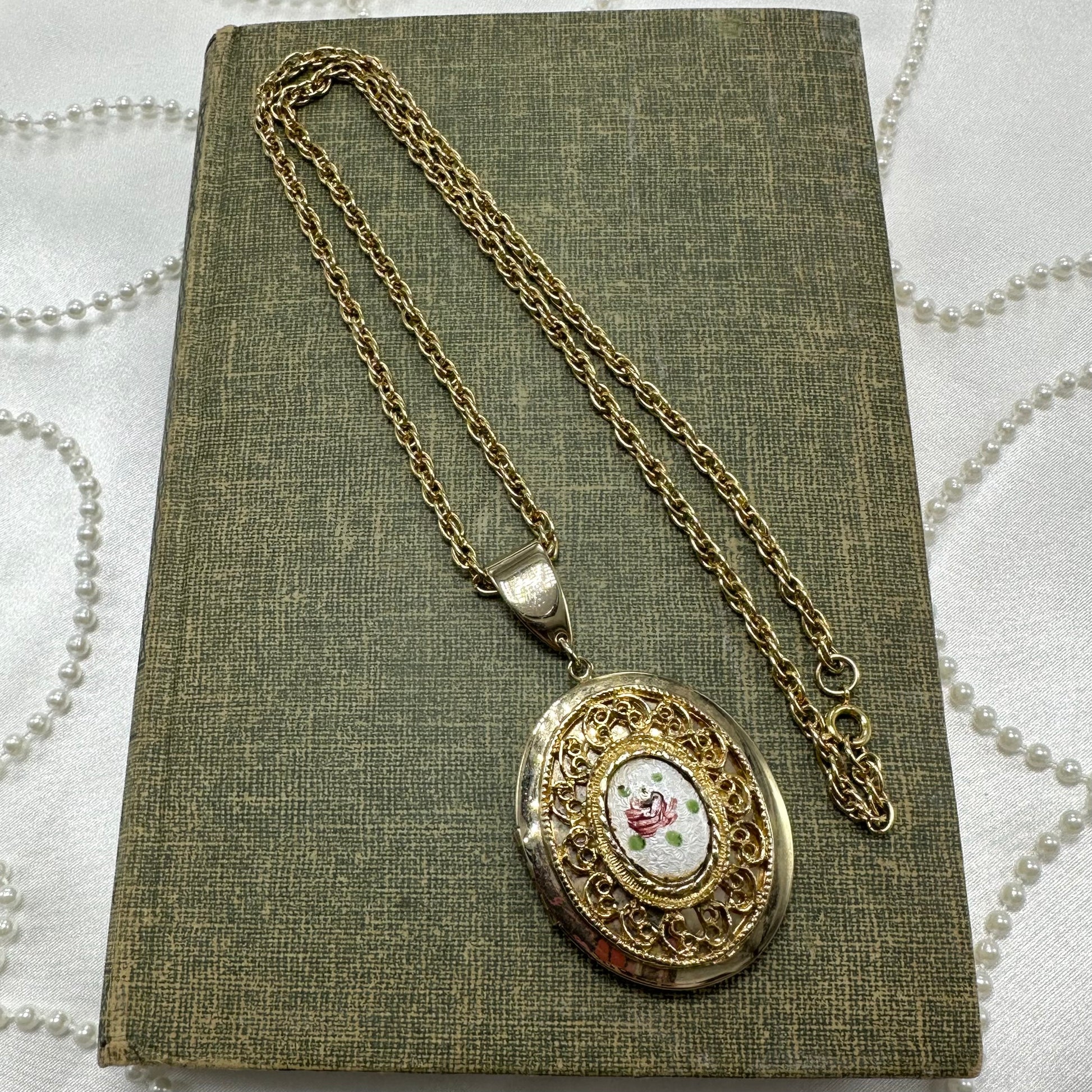 Vintage gold tone necklace with floral and filigree locket.