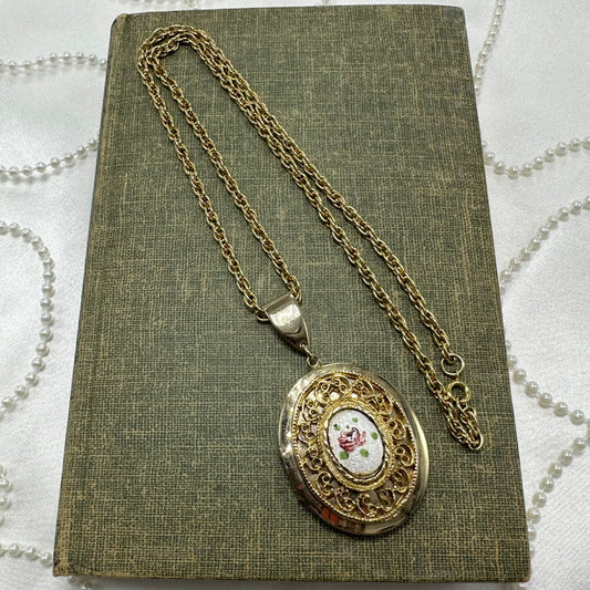 Vintage gold tone necklace with floral and filigree locket.