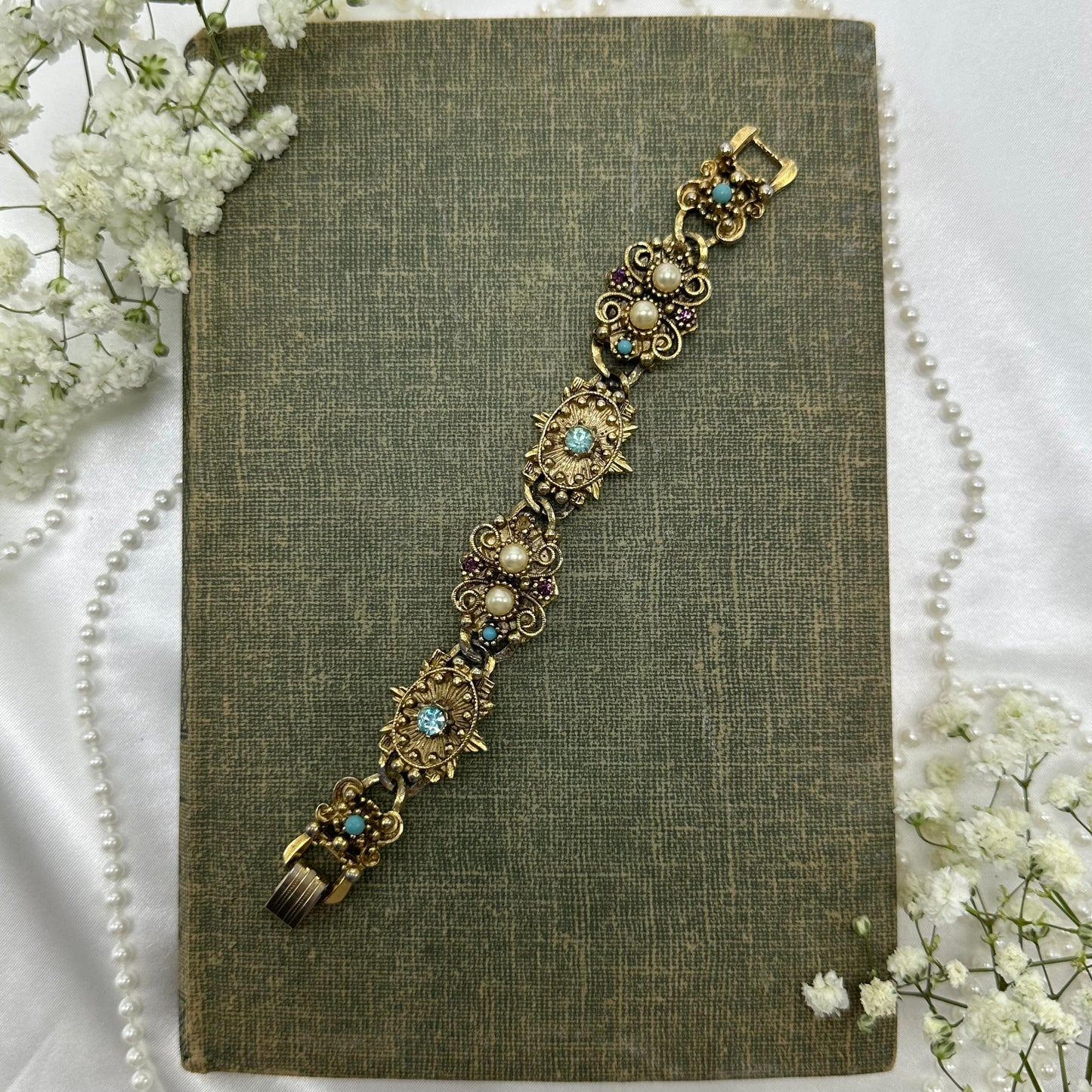Vintage gold tone ornate bracelet with faux pearls and gemstones.