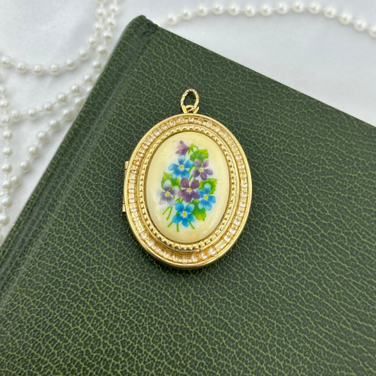 Vintage gold tone oval hanging photo locket by Avon with gorgeous blue and purple floral decal.