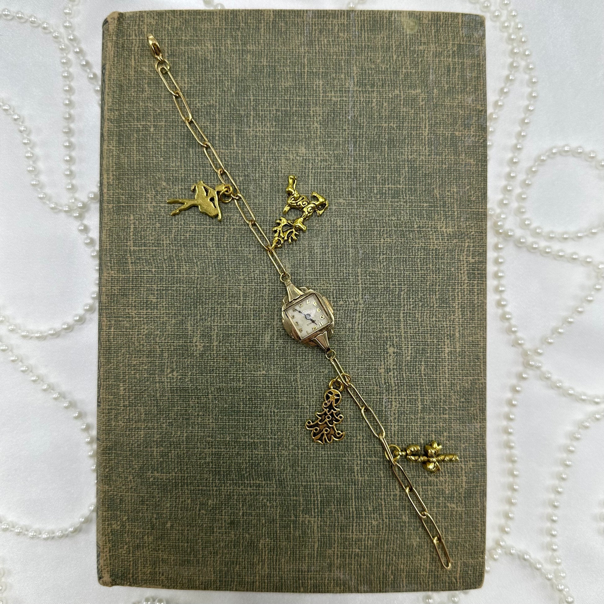 Vintage gold tone paperclip chain bracelet with Christmas charms. 14k GF Benrus watch does not run.