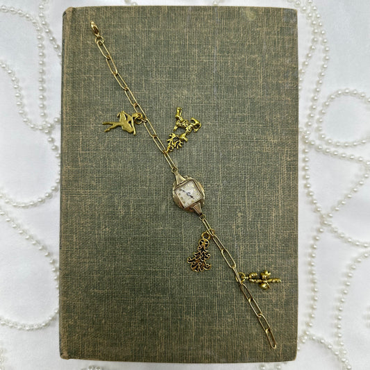 Vintage gold tone paperclip chain bracelet with Christmas charms. 14k GF Benrus watch does not run.