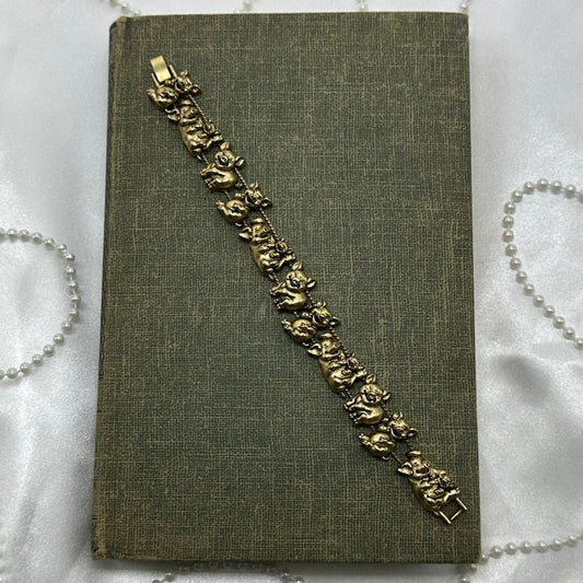 Vintage gold tone pig charm bracelet.