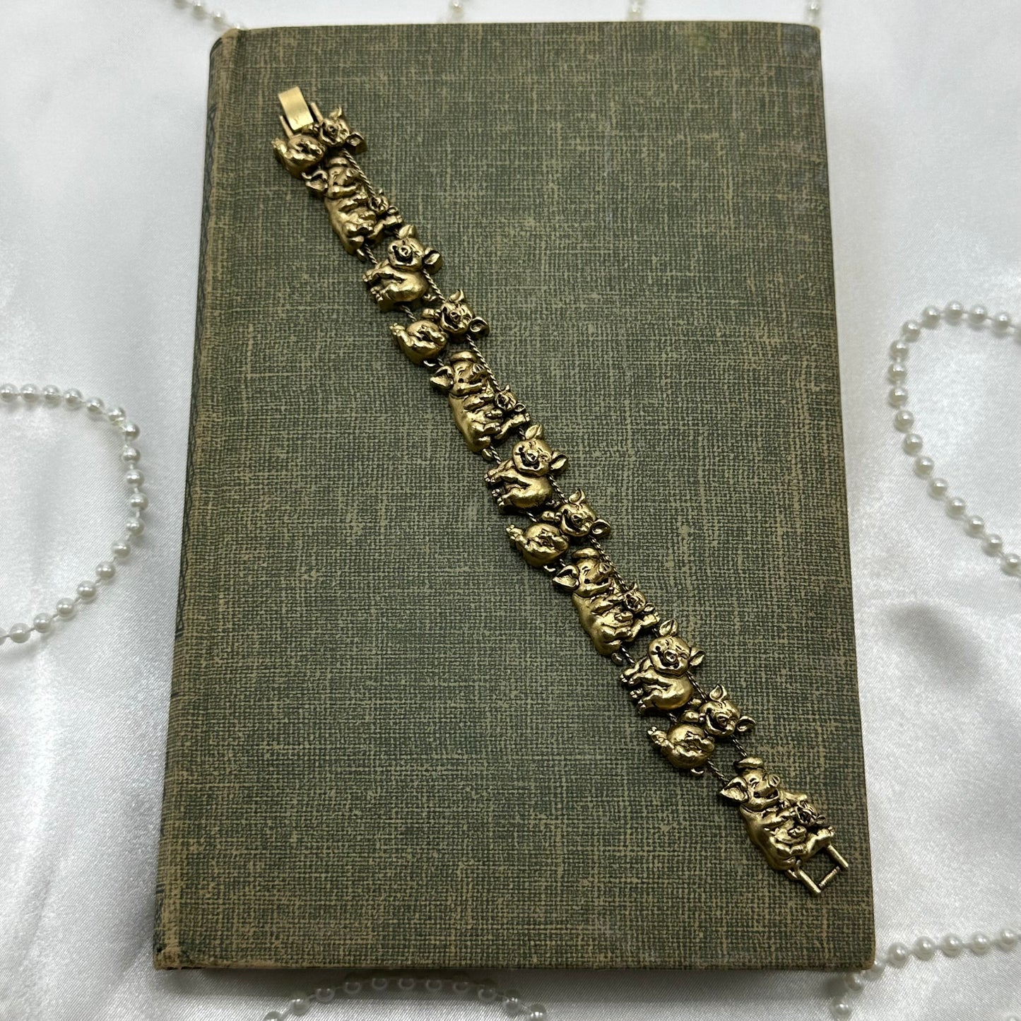 Vintage gold tone pig charm bracelet.