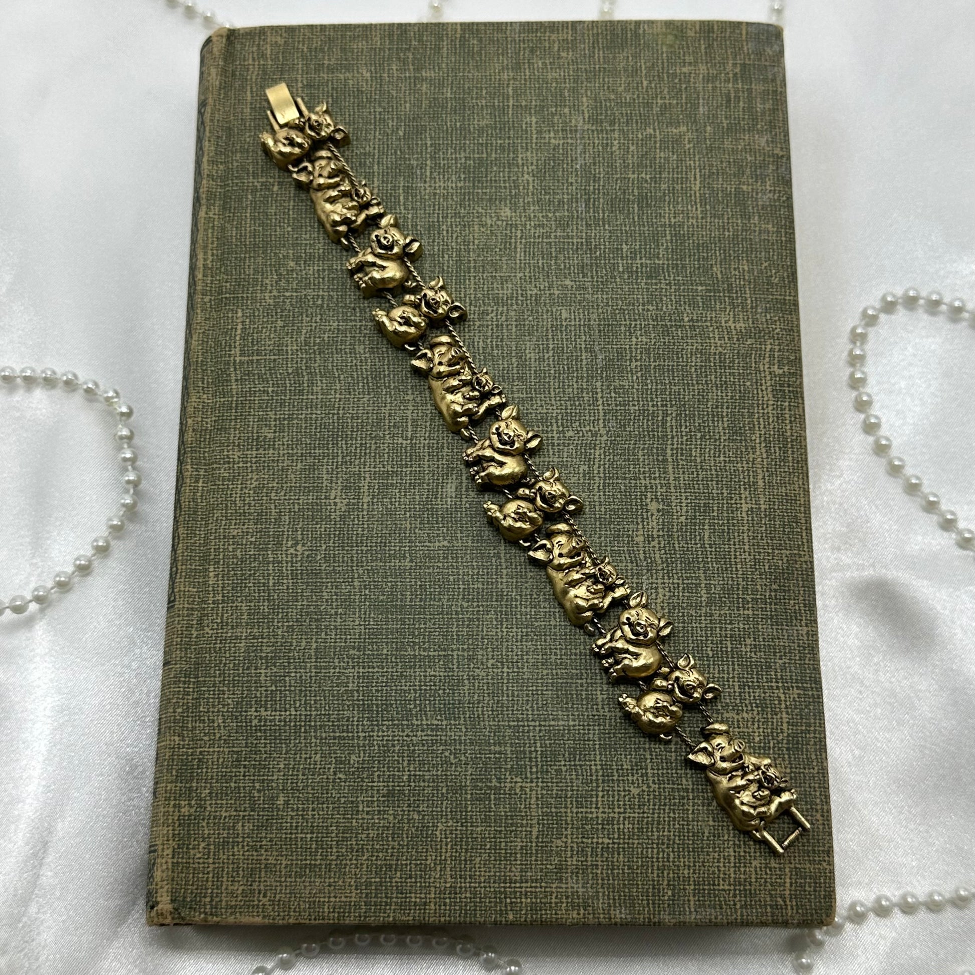 Vintage gold tone pig charm bracelet.