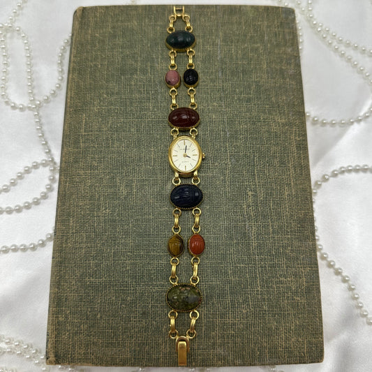 Vintage gold tone scarab watch with quartz movement.
