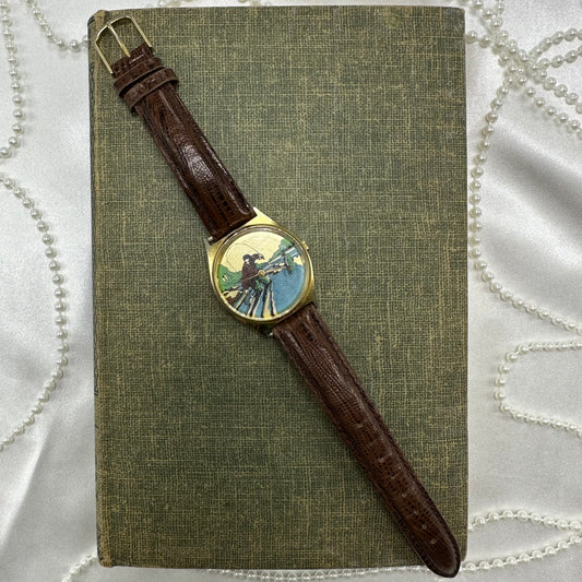 Vintage gold tone watch with unique picture of man fly fishing and quartz movement. Fish does not move