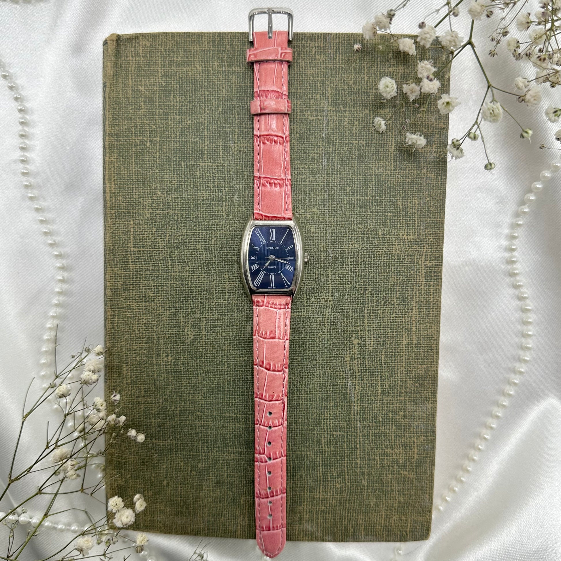 Vintage pink and silver tone Avenue watch with navy blue dial and quartz movement.
