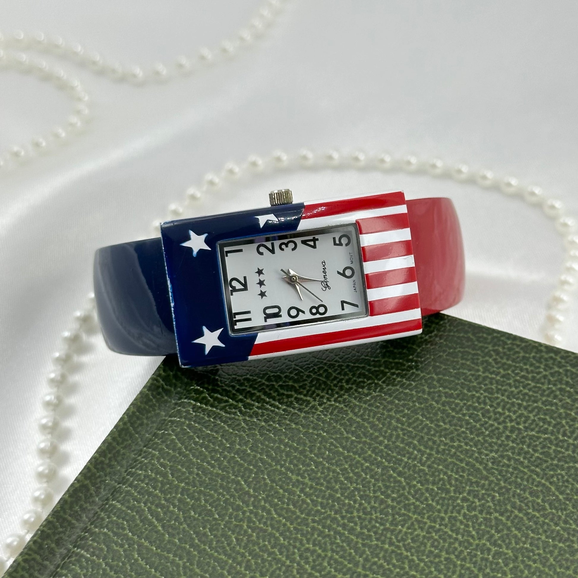 Vintage red, white, and blue Gevena cuff watch with rectangular American flag dial.