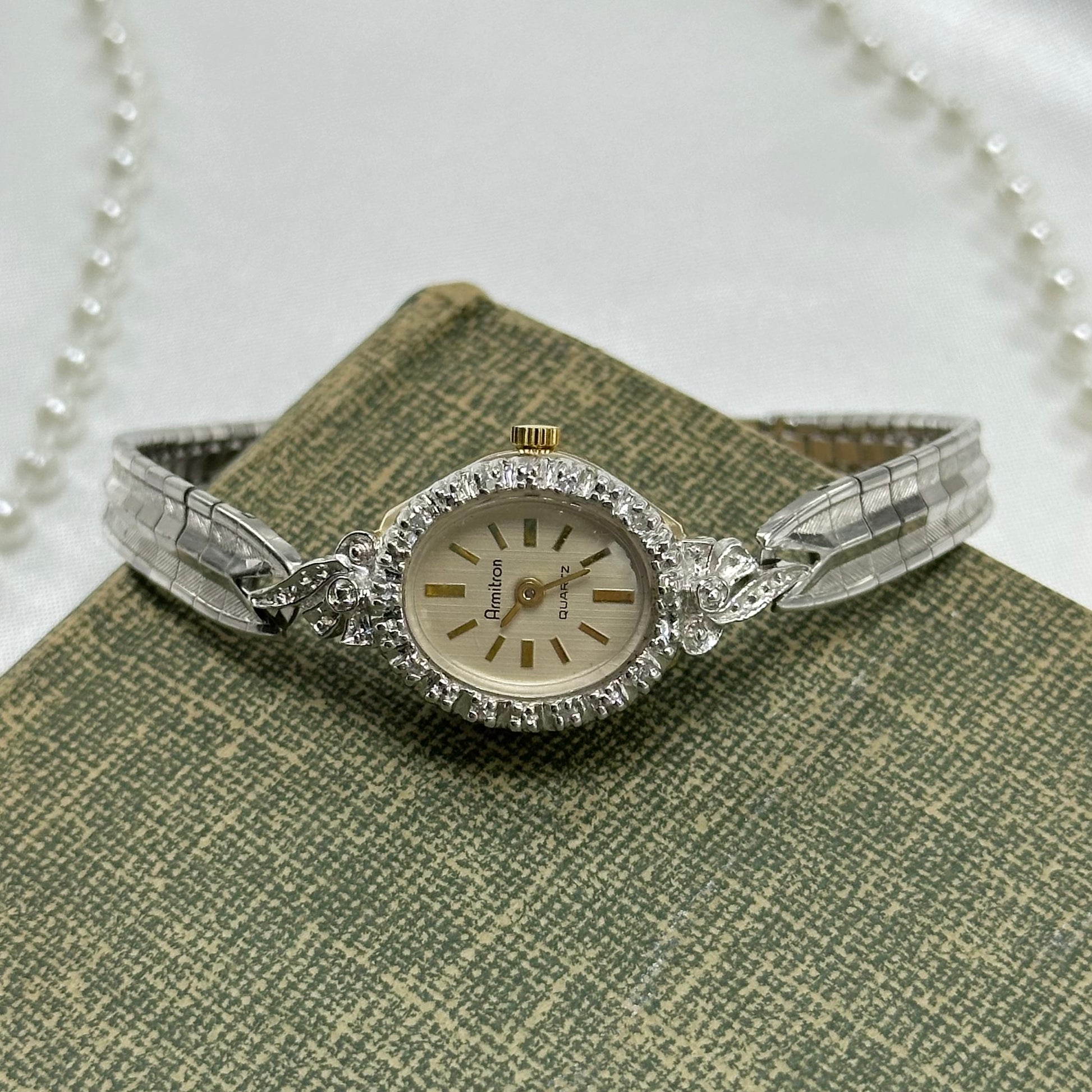Vintage silver and gold tone Armitron diamanté cocktail watch with quartz movement and clasp band.