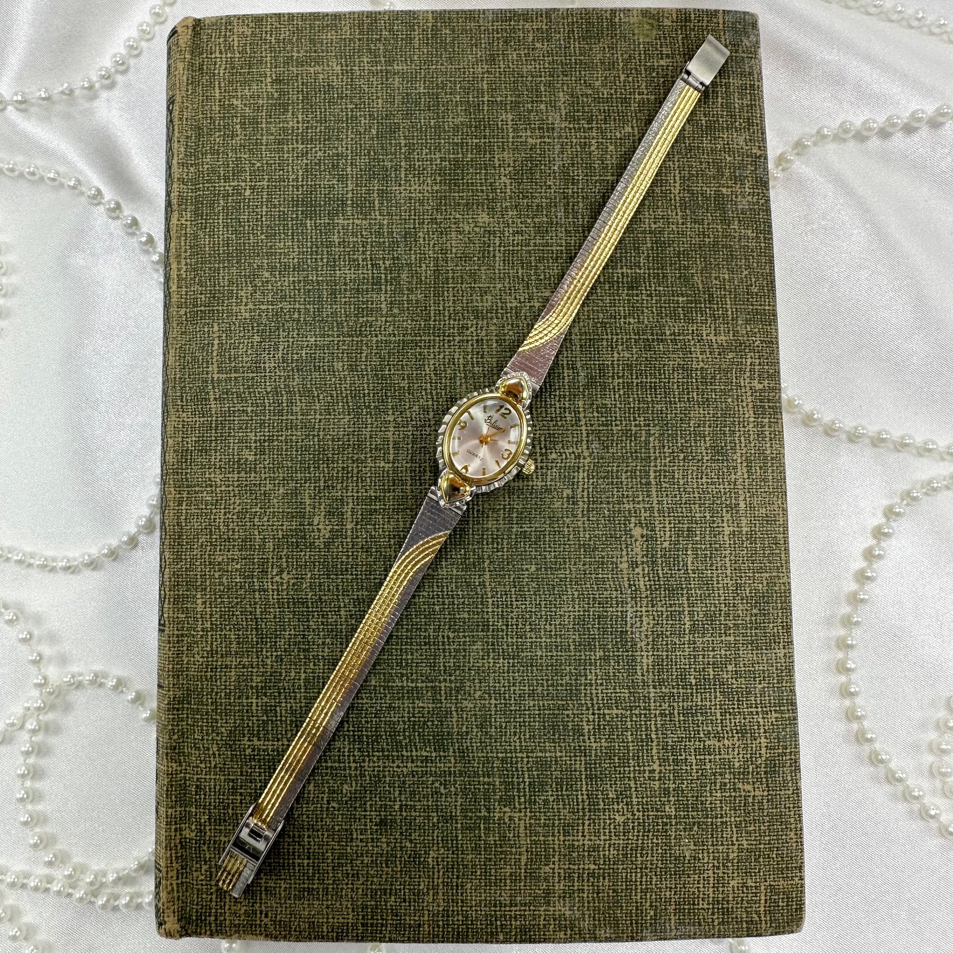 Vintage silver and gold tone Belisimo heart watch with detailed two-tone band and bubble dial.