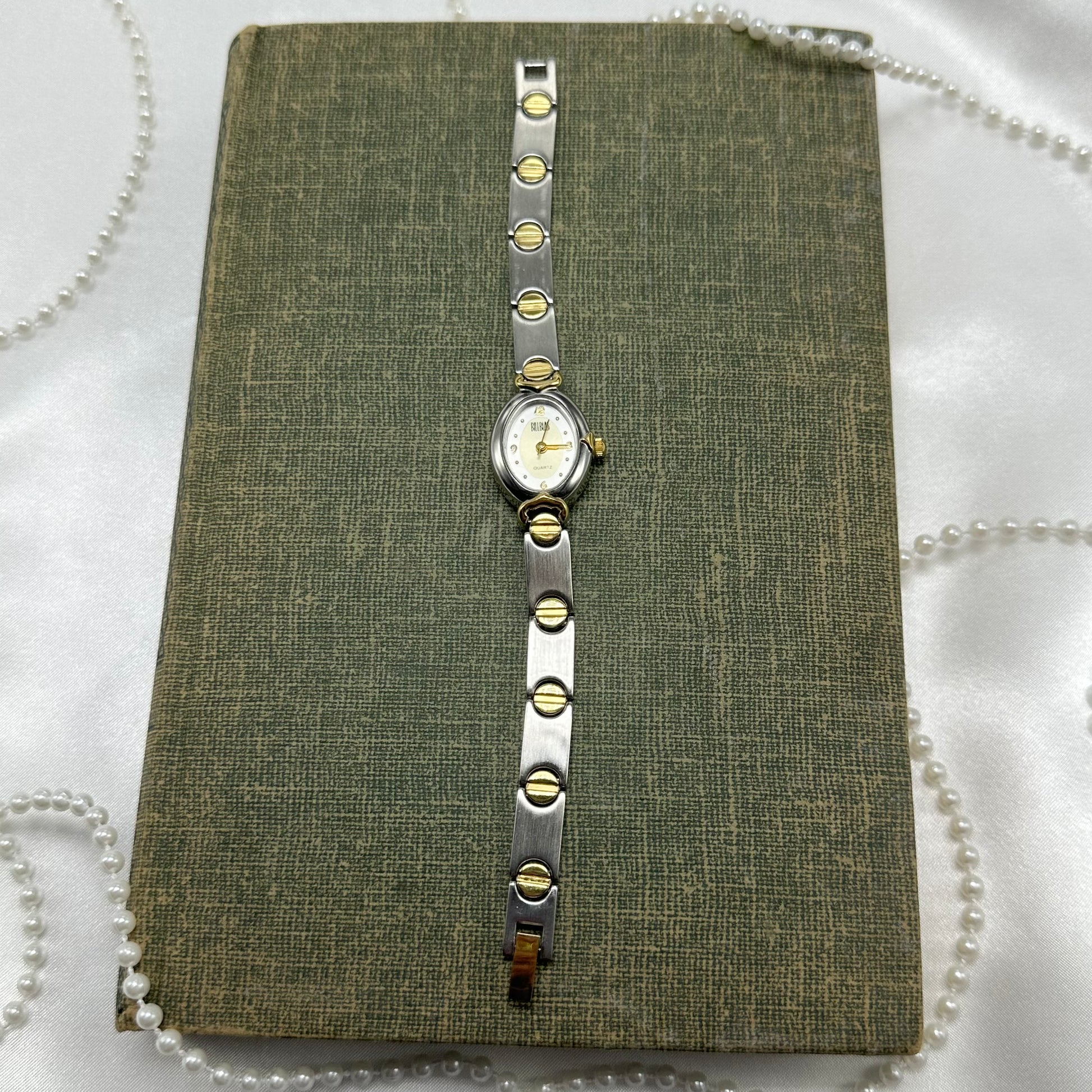 Vintage silver and gold tone Bliss Blass watch with quartz movement and clasp band