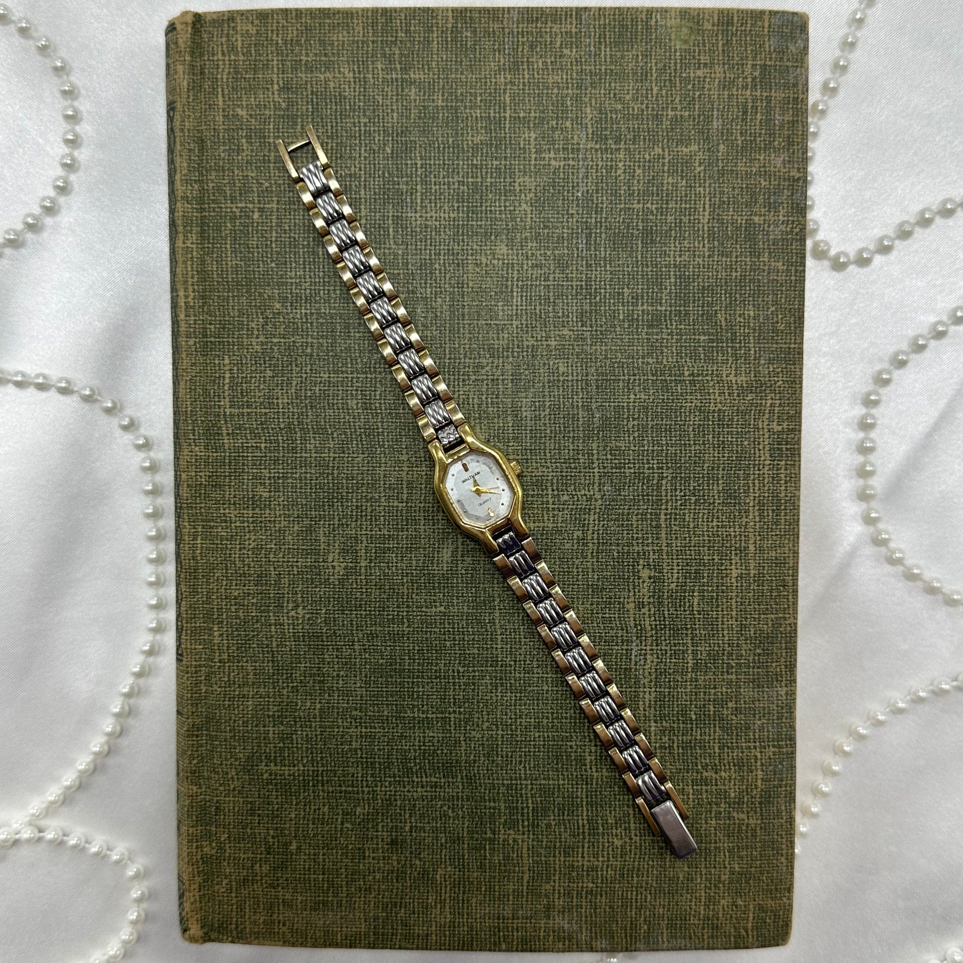 Vintage silver and gold tone Waltham watch with quartz movement.