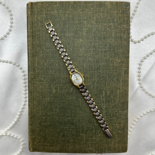 Vintage silver and gold tone Waltham watch with quartz movement.