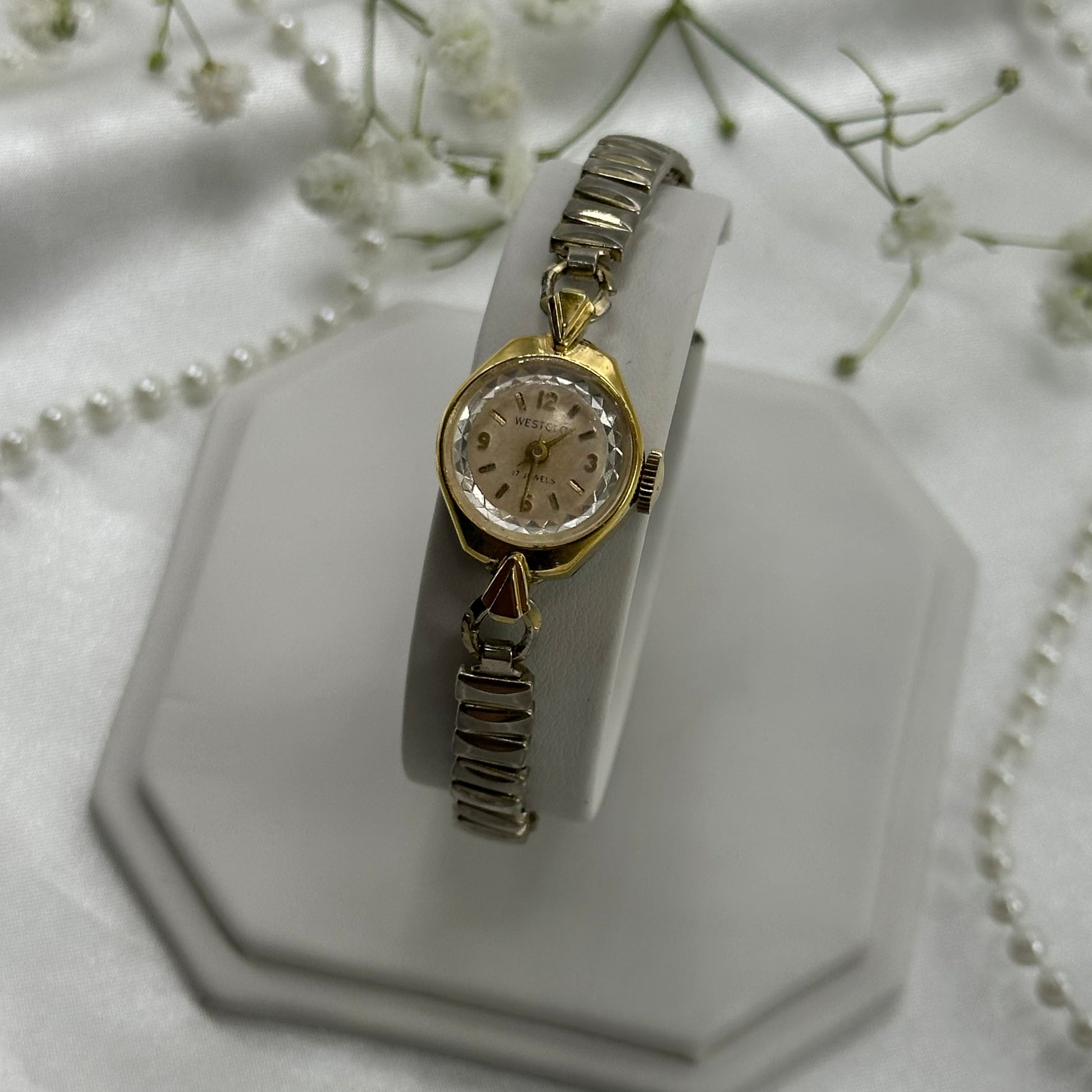 Vintage silver and gold tone Westclox manual winding cocktail watch with stretchable band.