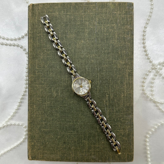 Vintage silver and gold tone Wrangler water resistant watch with blue jewel crown and quartz movement.