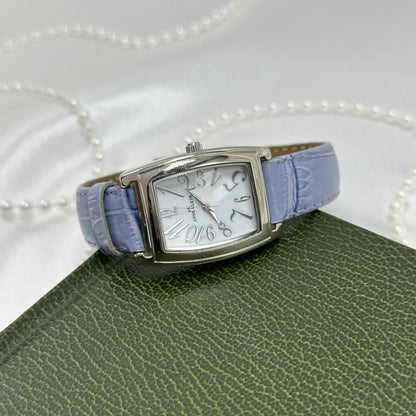 Vintage silver tone Anne Klein watch with rectangular dial and purple genuine leather band.