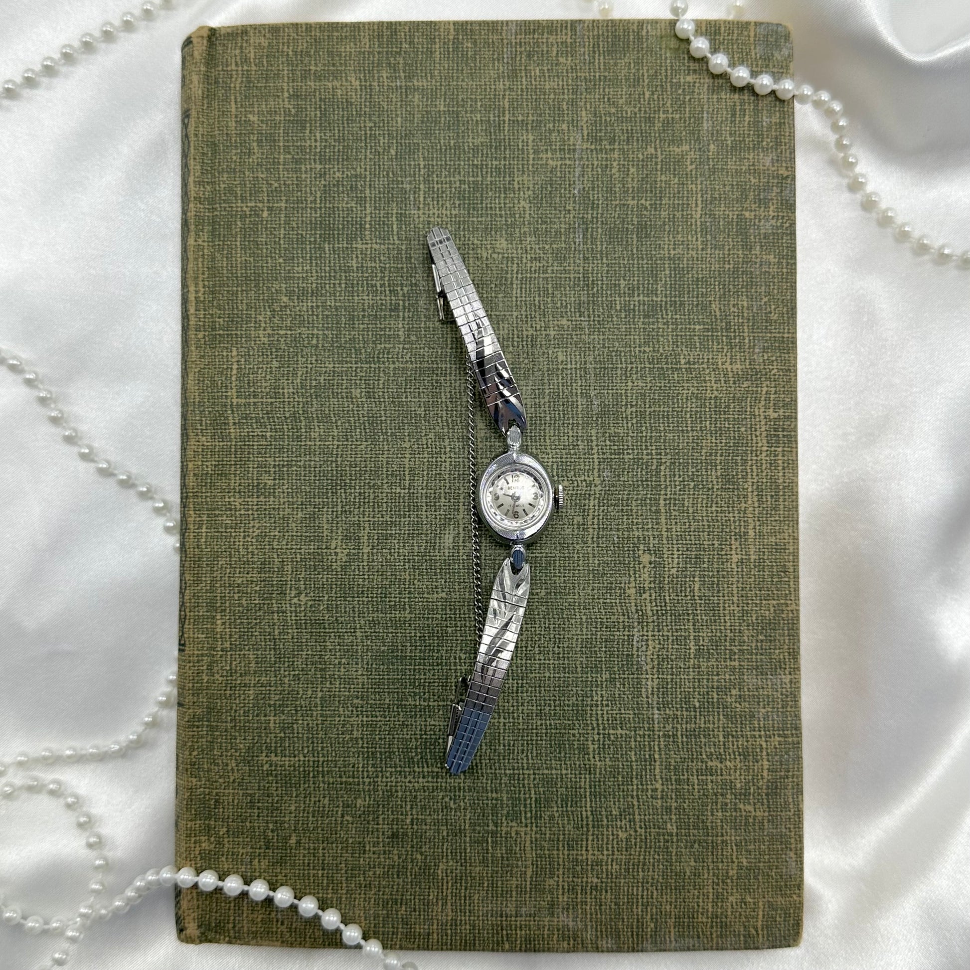 Vintage silver tone Benrus manual winding watch with detailed clasp band. Watch comes with original B crown.&nbsp;